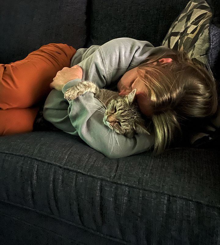 Sick cat sleeping on a girl's lap